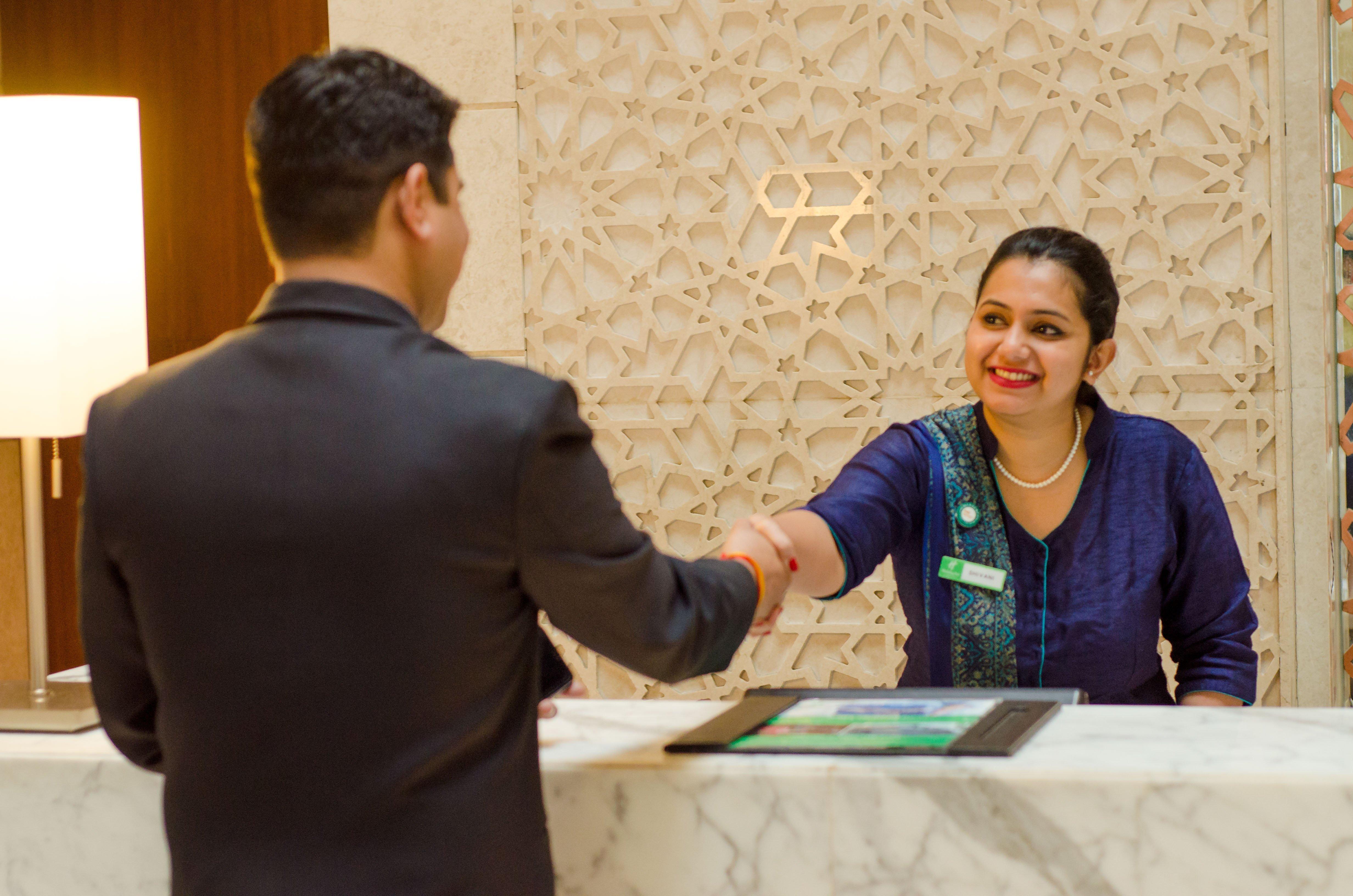 Holiday Inn Jaipur City Centre By Ihg Exterior photo A guest service agent at the front desk of a hotel